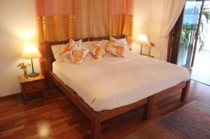 Teak bed with polished wood floors