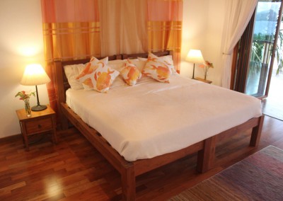 Teak bed with polished wood floors